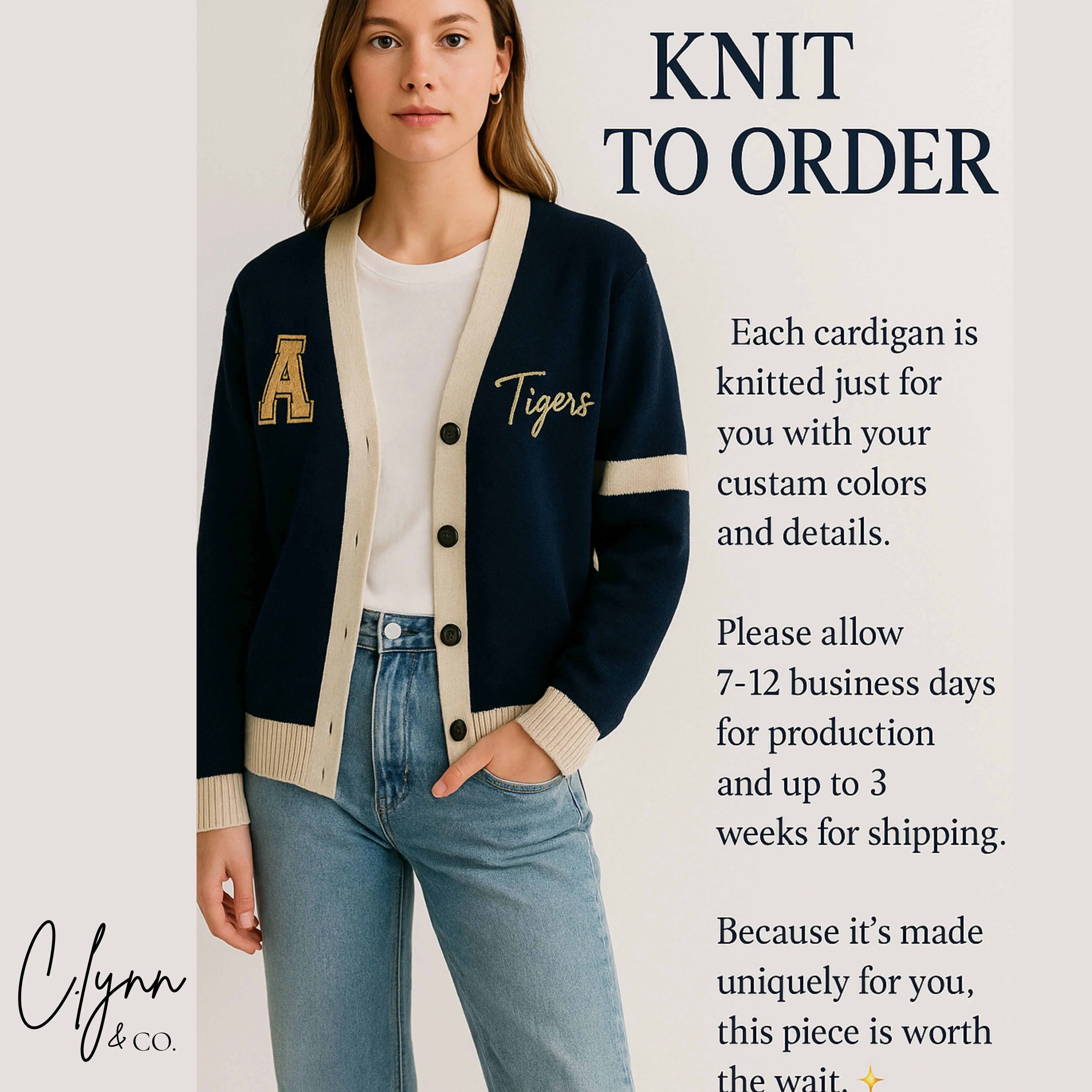 Woman wearing navy varsity cardigan with cream accents, letter A patch, Tigers script, and jeans