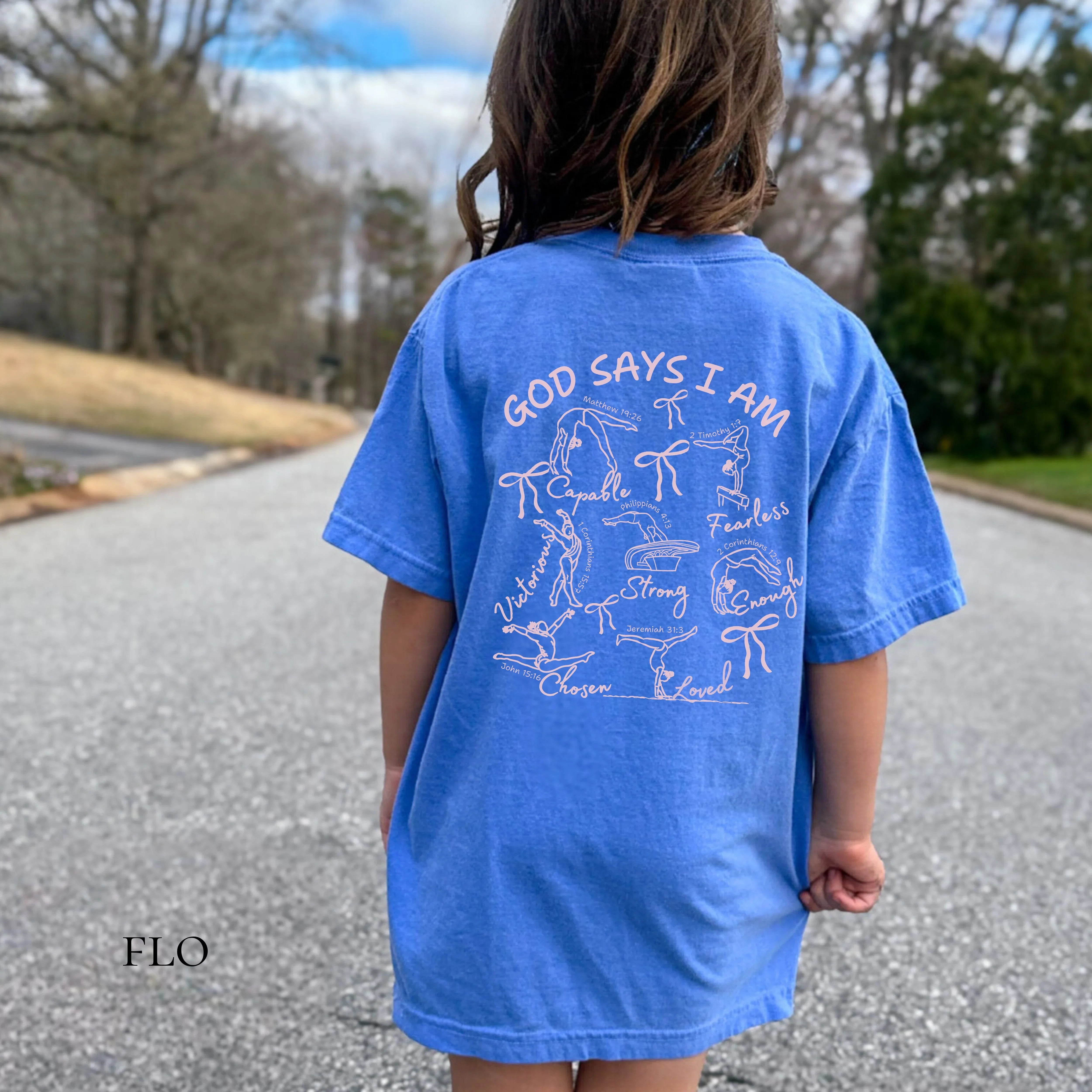 Child wearing a blue t-shirt with Christian Faith Based Gymnastics text and graphics God Says I Am