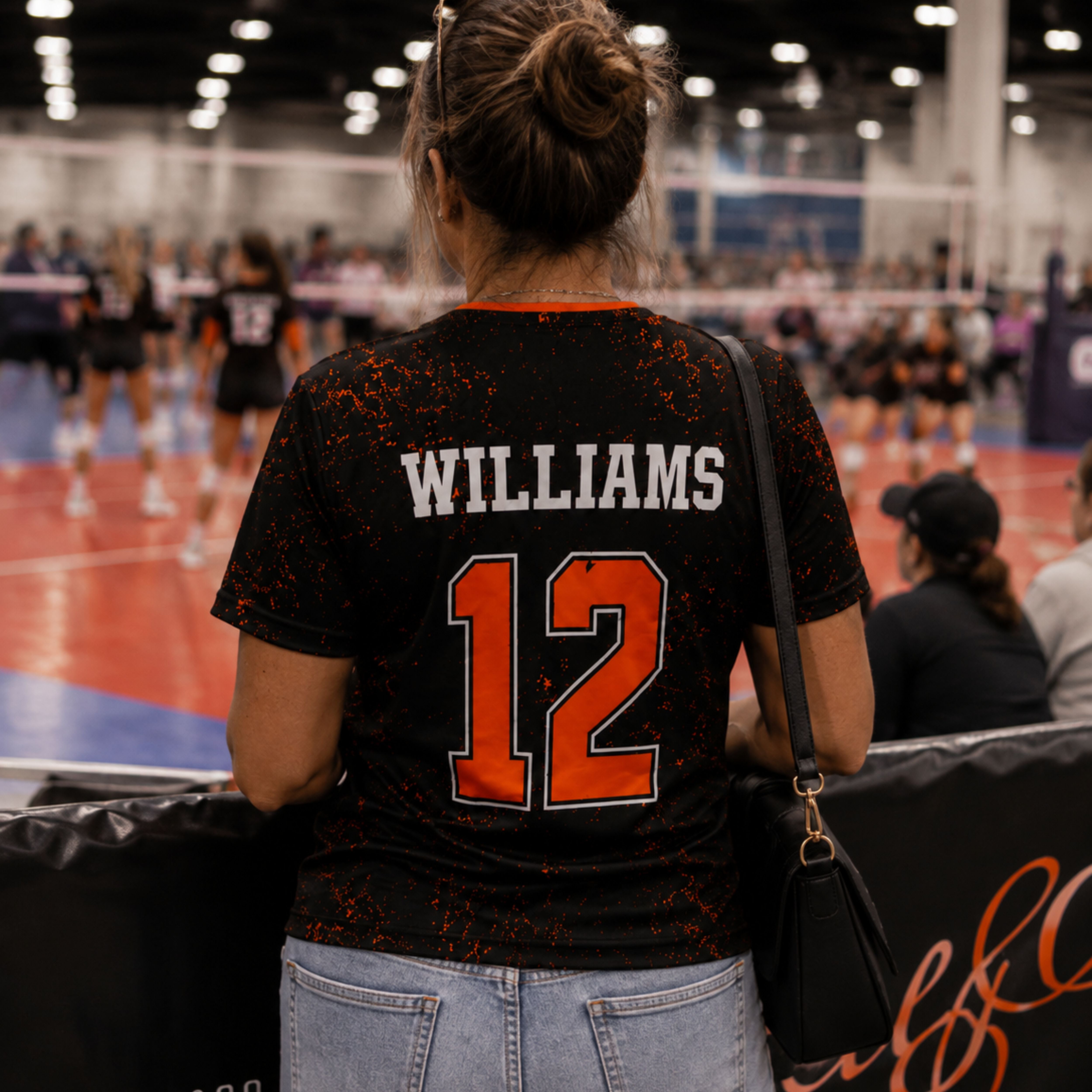 Custom volleyball jersey back view with arched player name and number in the stands