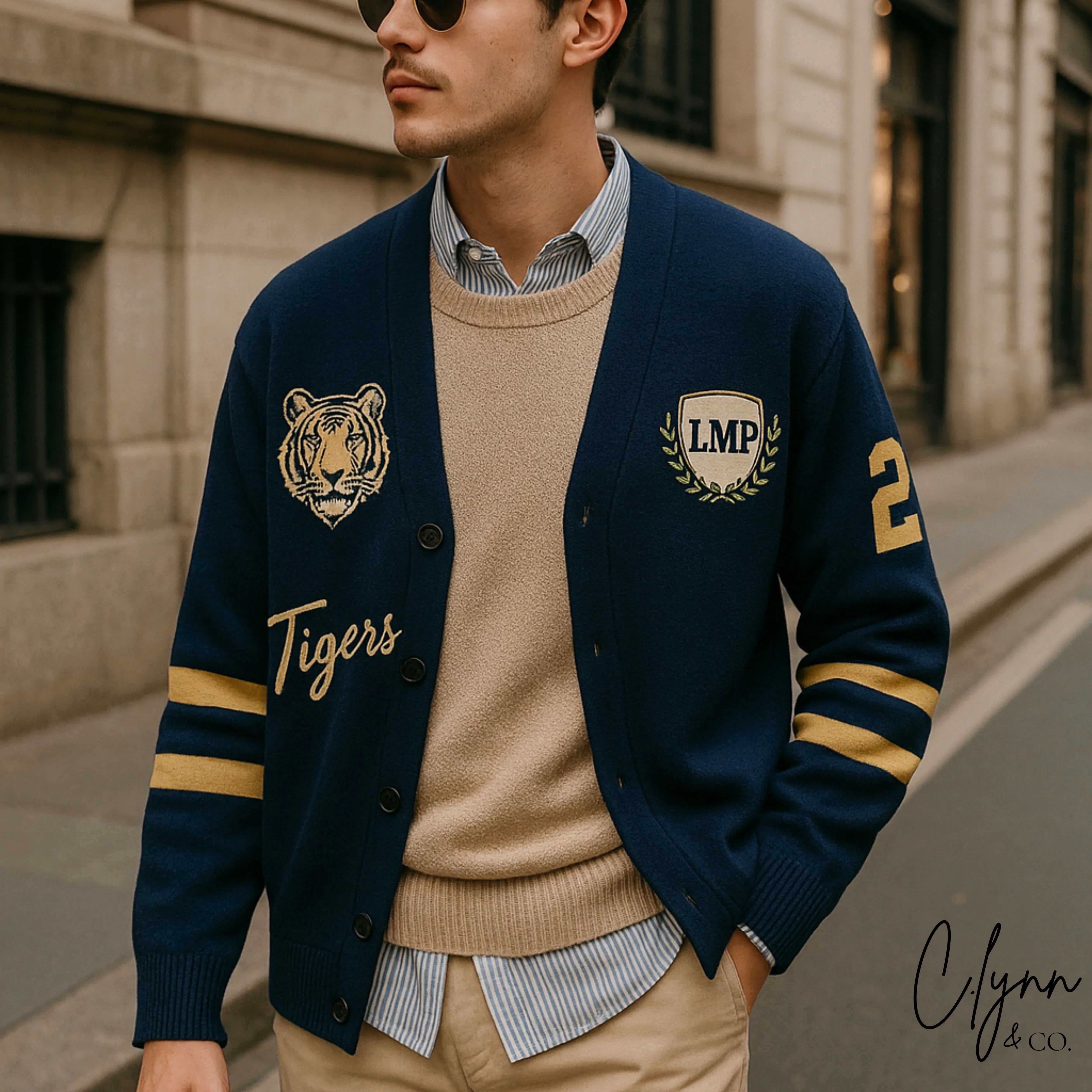 Man wearing blue varsity cardigan with tiger patch, LMP crest, and gold stripes on city street