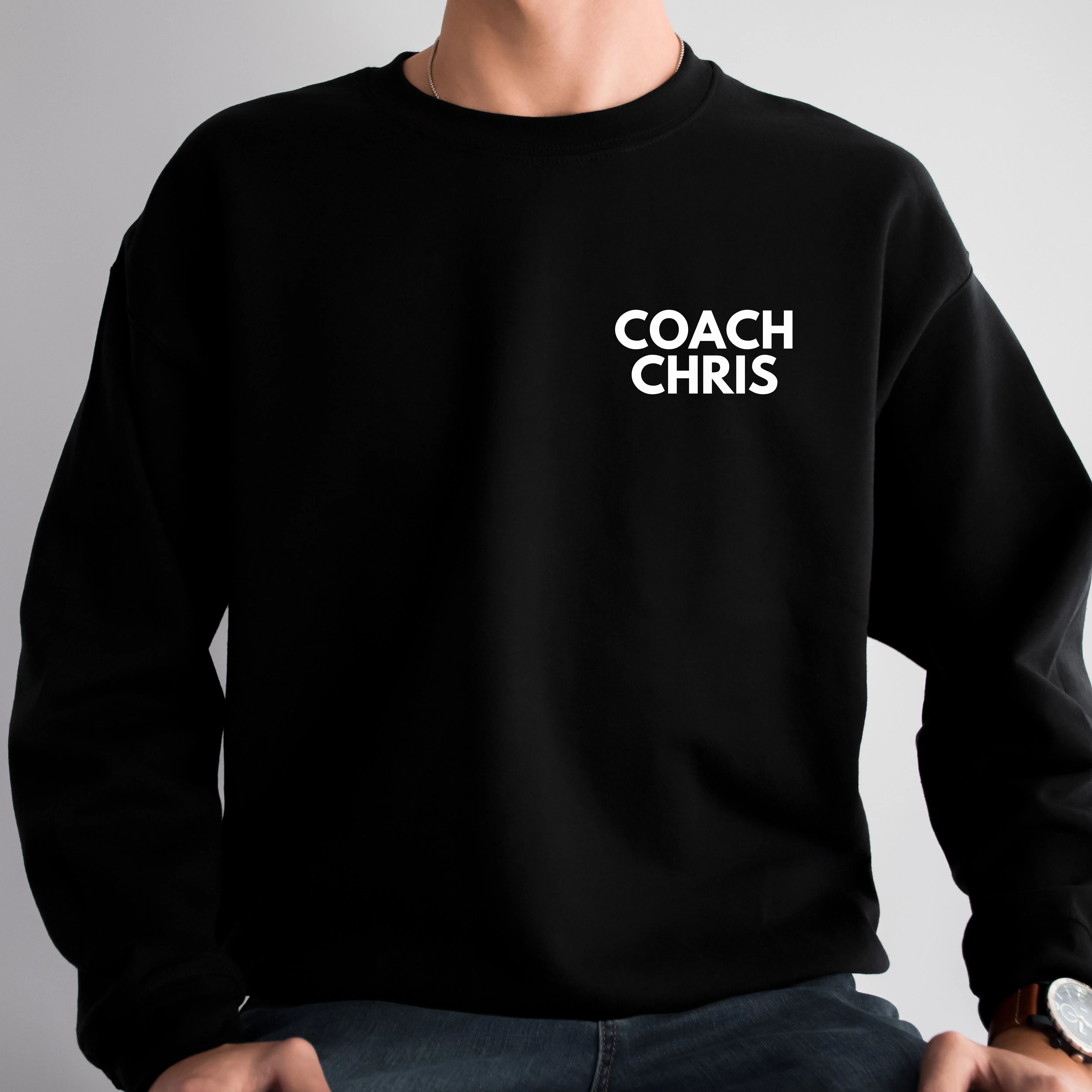 Black sweatshirt with Customized 'COACH CHRIS' text on a gray background