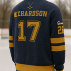 Navy blue hockey varsity sweater with gold stripes, 'Richardson 17' on back, ice rink setting