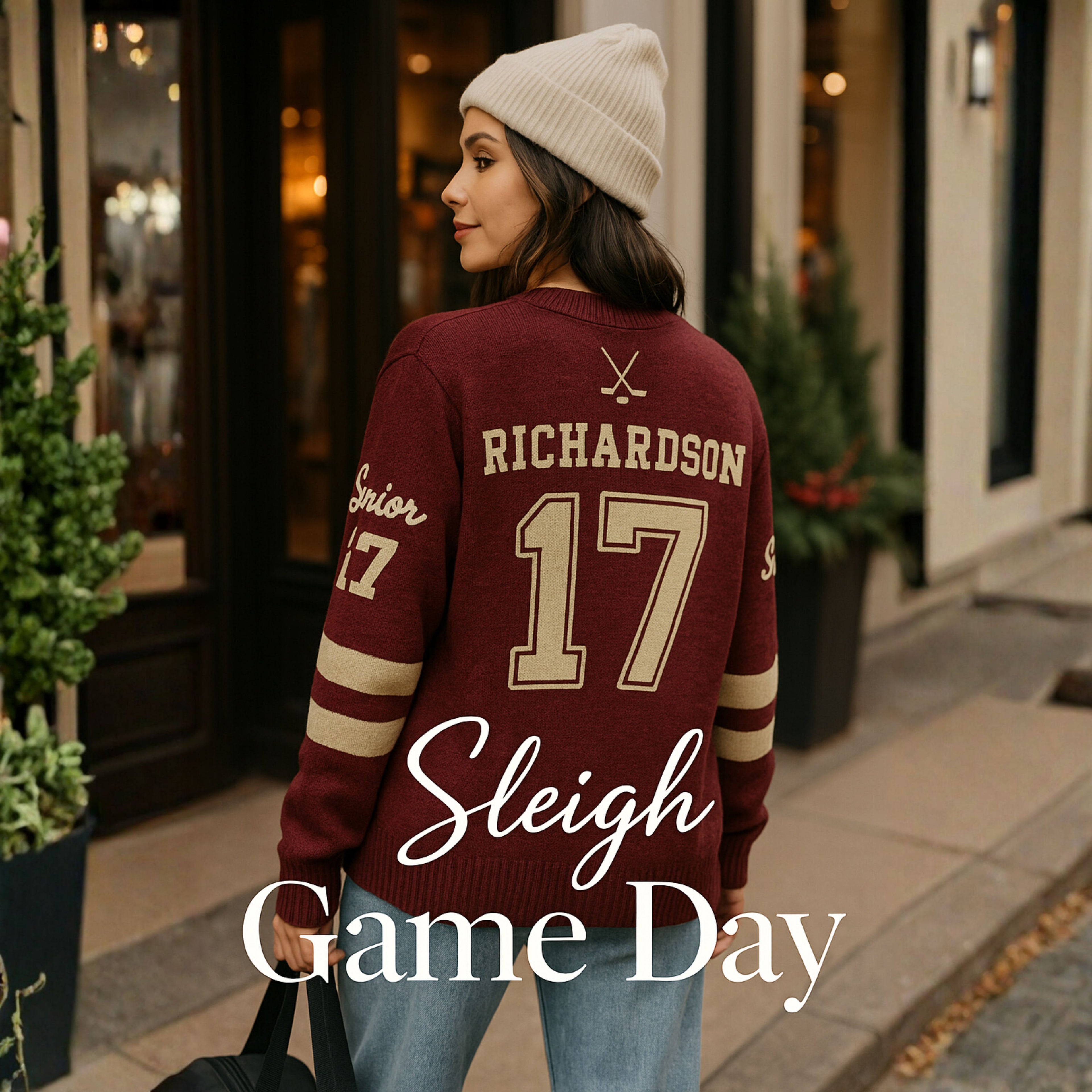 Woman in maroon varsity sweater with 'Richardson 17,' cream beanie, casual game day outfit