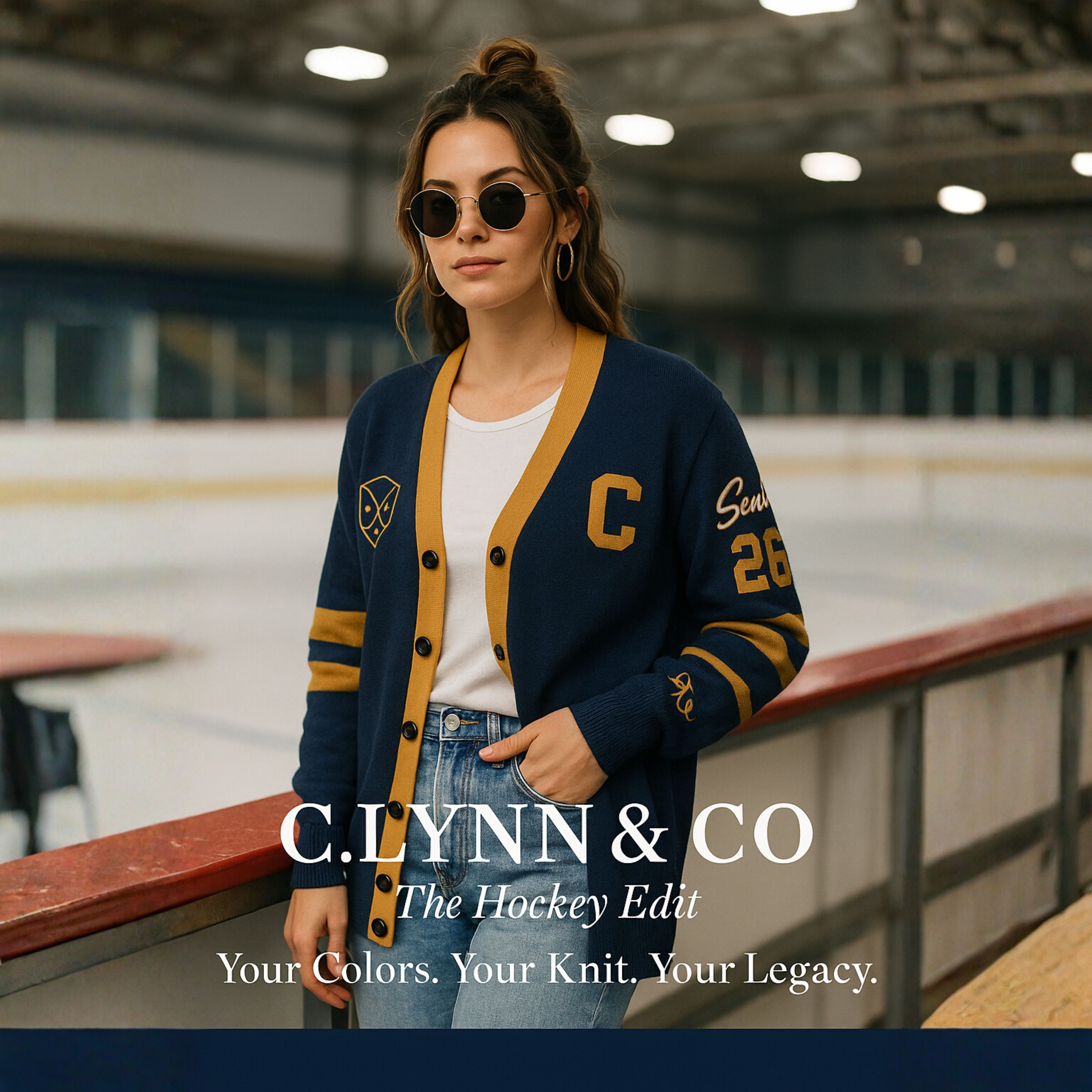 Woman in varsity hockey cardigan at indoor ice rink, wearing sunglasses and hoop earrings