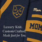 Navy blue knit sports parent sweater with gold hockey crest and 'Mom' text details.
