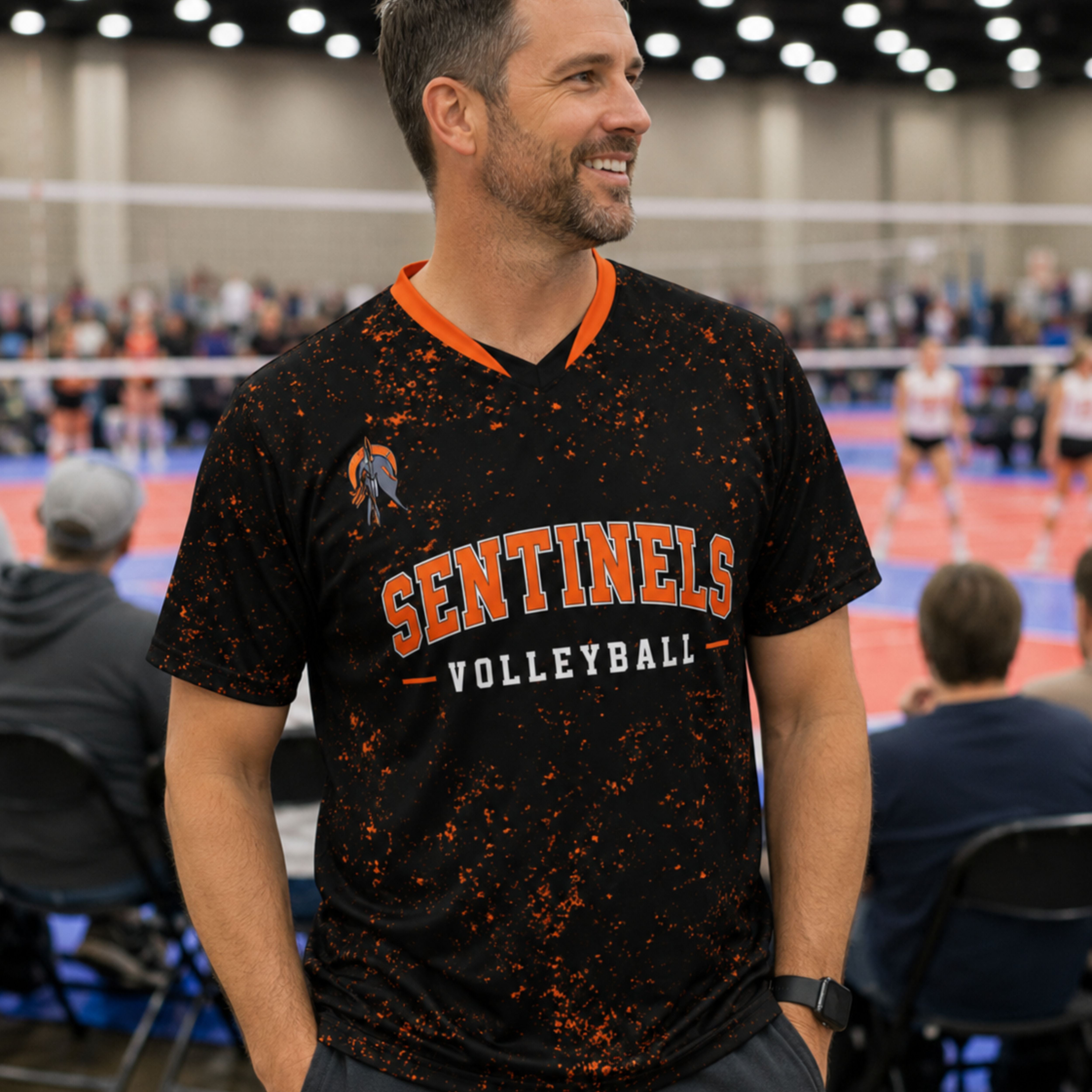 Dad in the stands wearing a custom black and orange volleyball team jersey at a club tournament