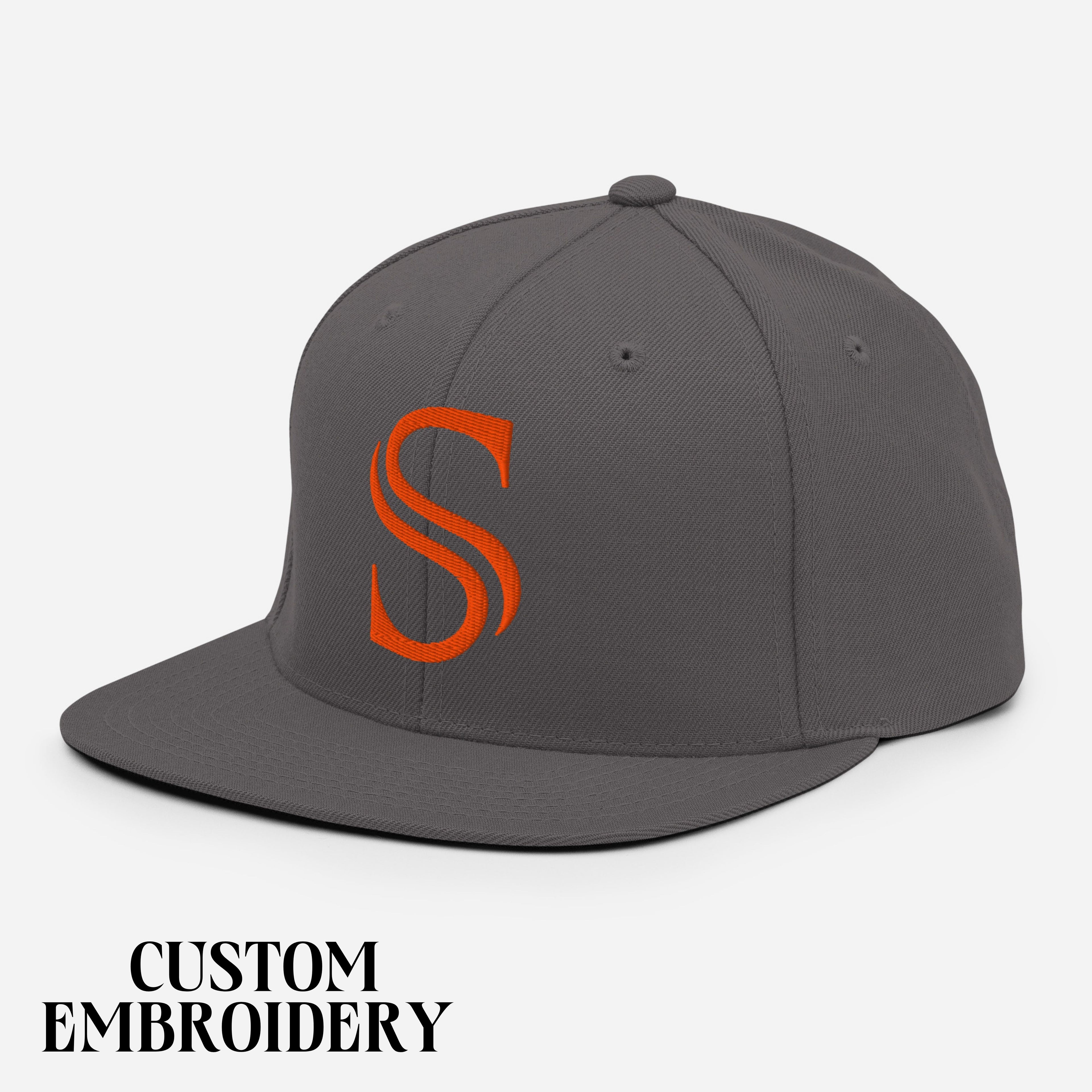 Gray snapback hat with orange embroidered S logo, custom sports apparel, white background