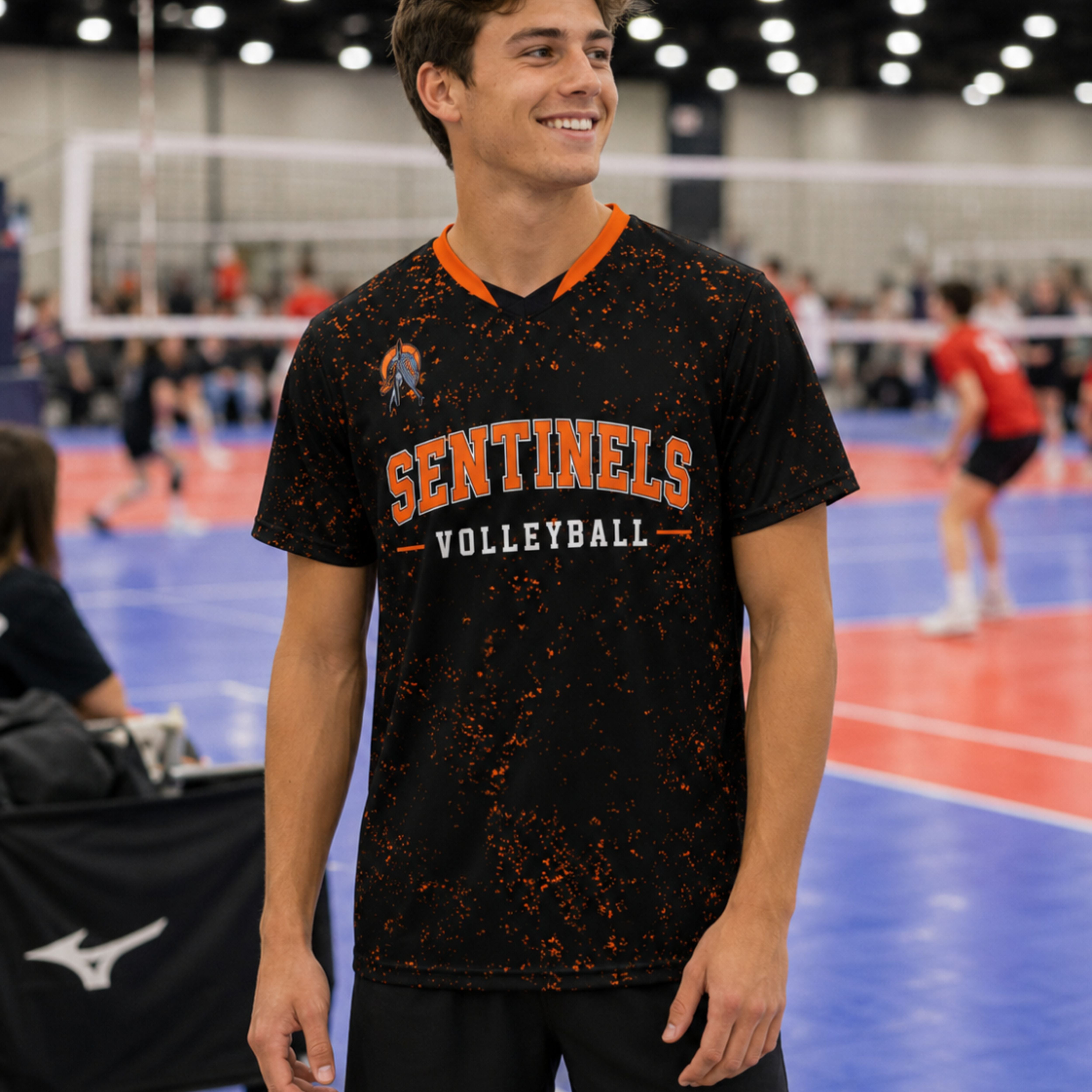 Male volleyball player wearing a custom black and orange team jersey at a tournament