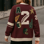 Maroon varsity-inspired sweater with sports patches, number 2, football motifs, and cream accents.