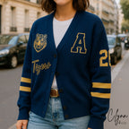 Woman wearing blue varsity cardigan with tiger patch, letter A, yellow stripes, and number 23
