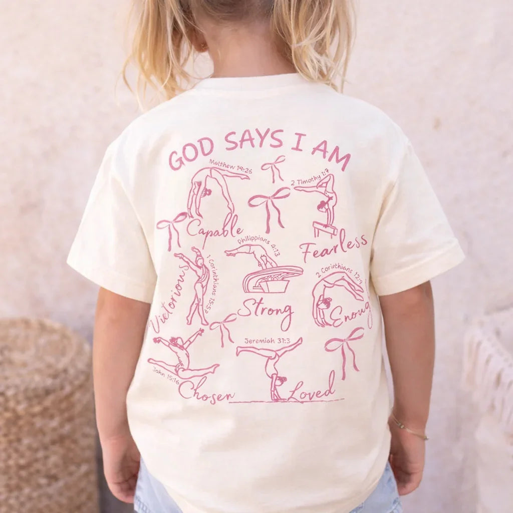 Child wearing a white t-shirt with pink God Says I Am Christian Athlete Gymnastics motivational text and graphics.