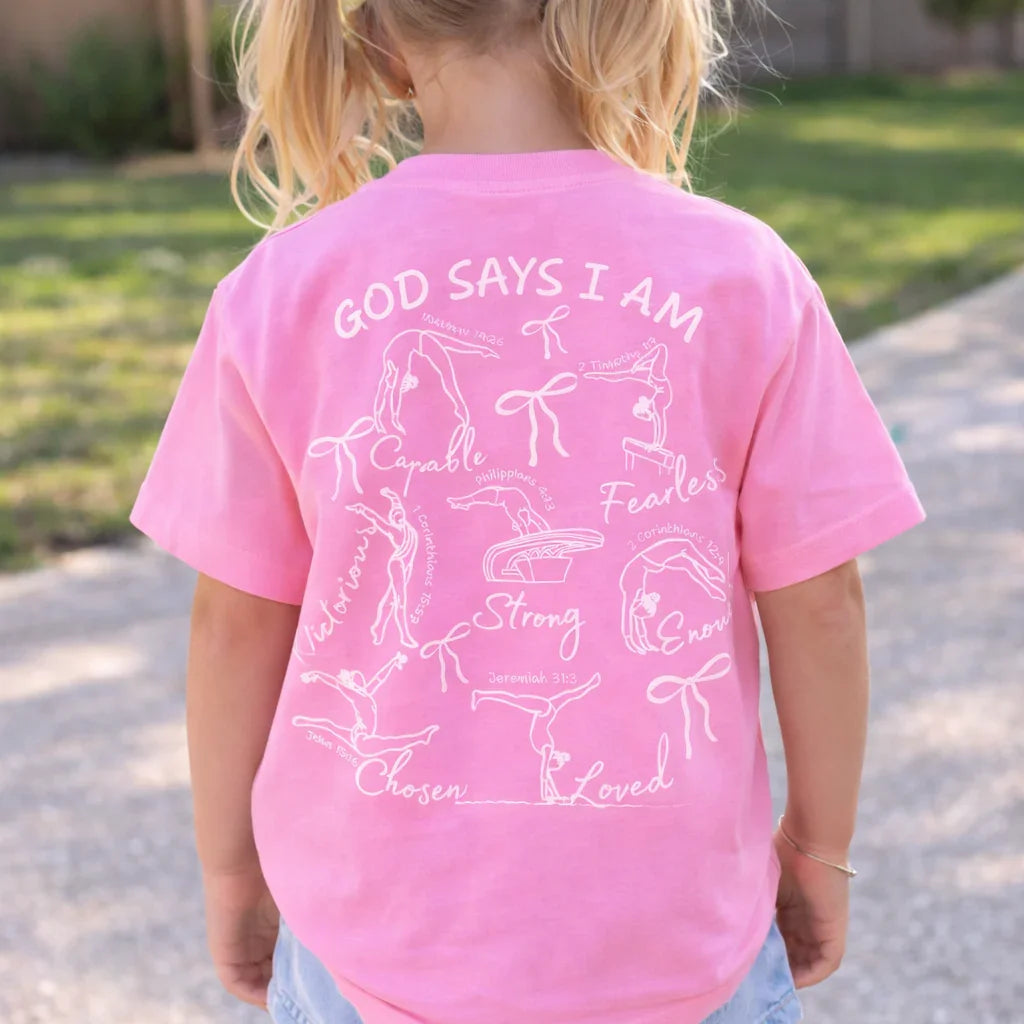 Child wearing a pink t-shirt with motivational faith based gymnastics phrases
