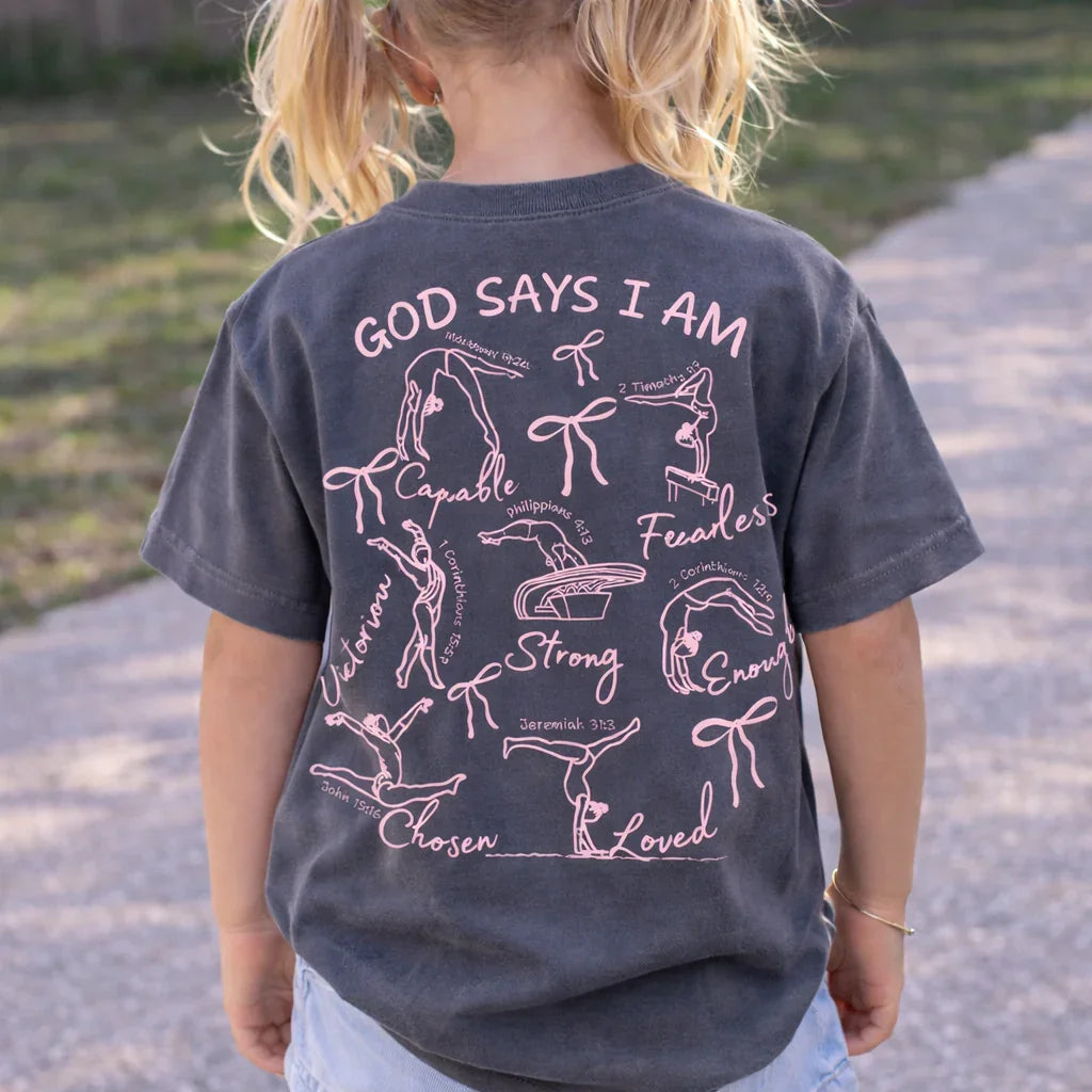 Child wearing a t-shirt with motivational text and graphics on the back. God Says I Am gymnastics t-shirt