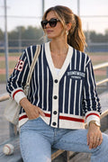Woman in striped Homewood Patriots varsity cardigan and jeans at a baseball field