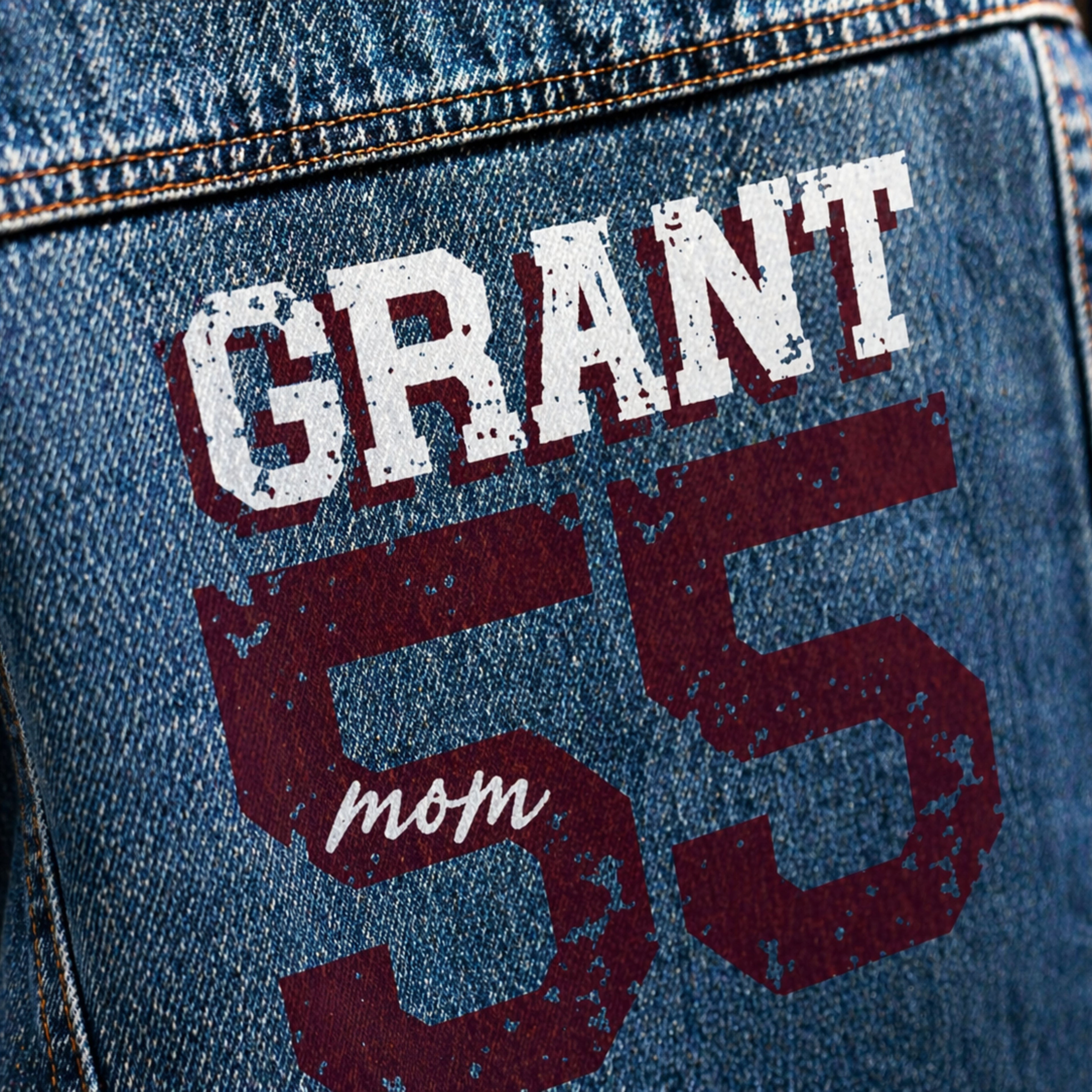 Denim jacket with 'GRANT mom 55' text in white and red on a blue background