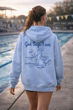 Person wearing a royal blue hoodie with God Says I am Faith based text and swimmer 