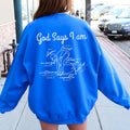 Person wearing a blue sweatshirt with motivational text on the back, standing on a sidewalk.