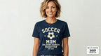 Woman wearing a navy blue t-shirt with 'Soccer Mom' text and soccer ball graphic on a light gray background.
