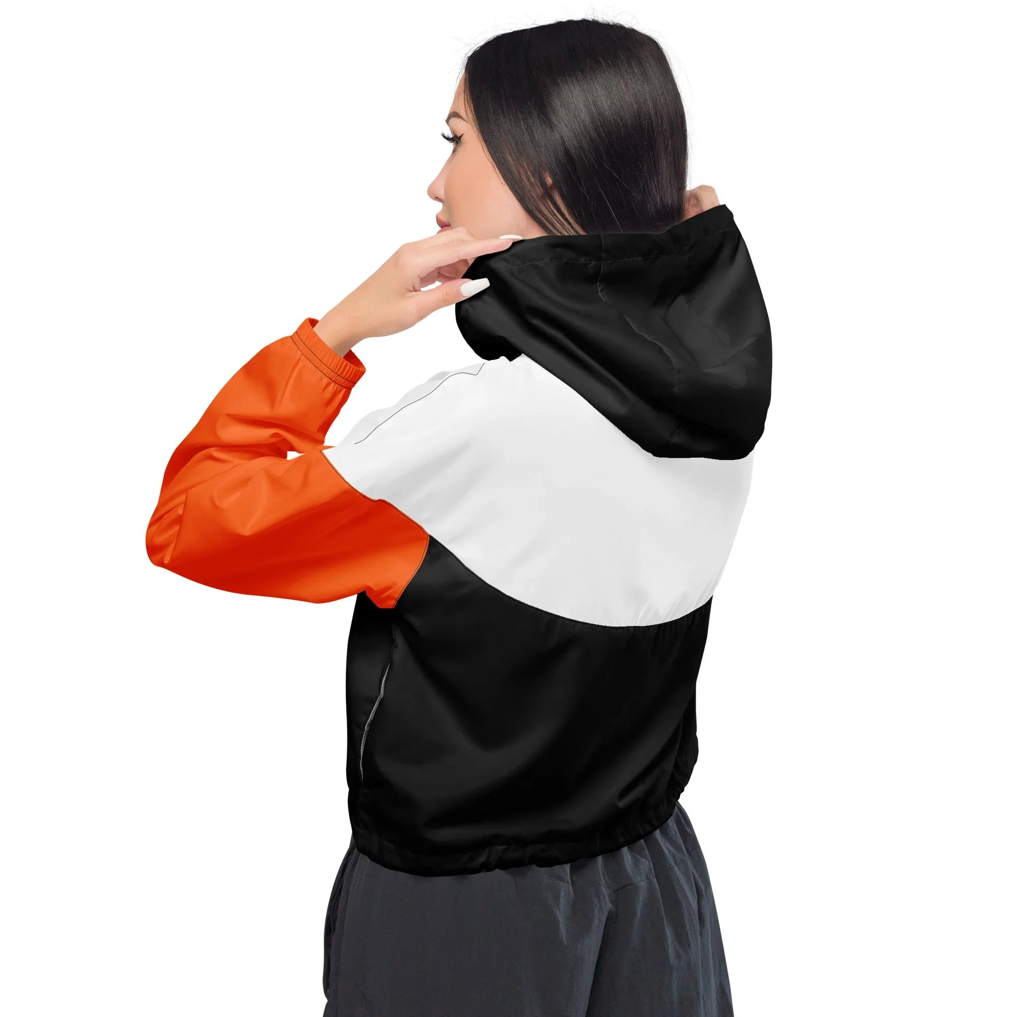 Person wearing a black, white, and orange jacket on a white background