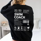 Black Swim Coach Ingredient Label Sweatshirt with white text worn by a woman