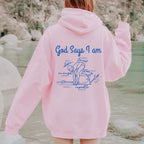 Person wearing a royal blue hoodie with God Says I am Faith based text and swimmer 