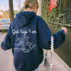 Person wearing a royal blue hoodie with God Says I am Faith based text and swimmer 
