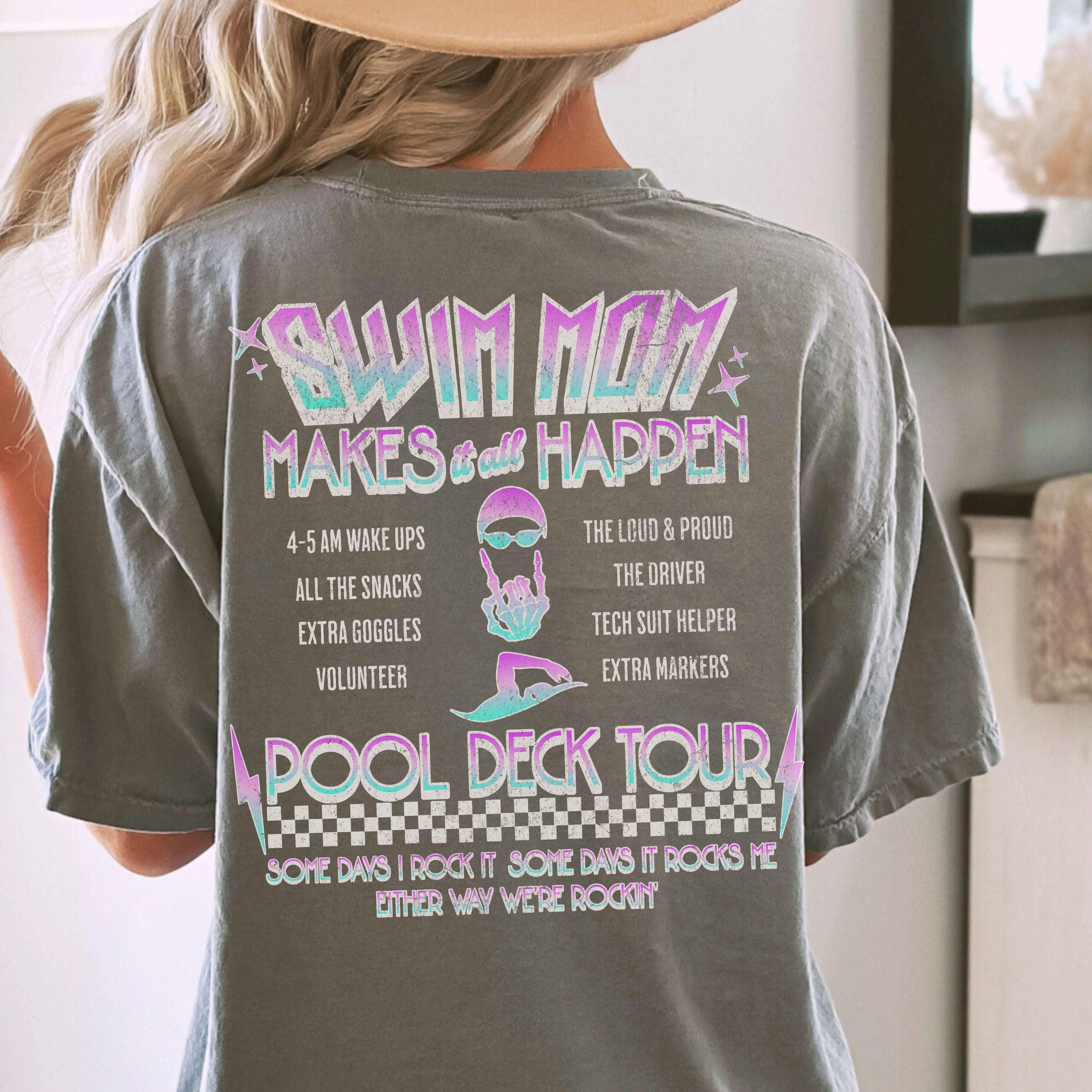 Person wearing a t-shirt with 'Swim Mom' text and graphics on the back.