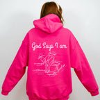 Person wearing a bright pink hoodie with God Says I am Faith based text and swimmer 